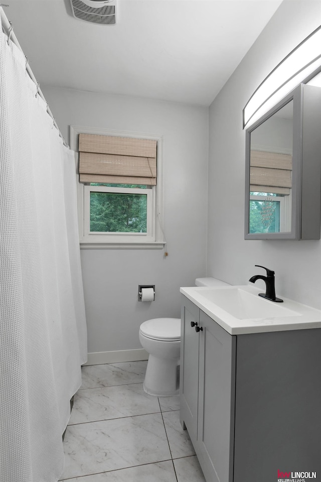 3920 Randolph St, Lincoln, NE 68510 - full bath featuring marble finish floors, vanity, and toilet