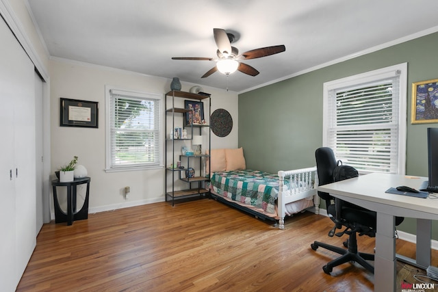3920 Randolph St, Lincoln, NE 68510 - bedroom with wood finished floors, ornamental molding, an office area, baseboards, and a closet
