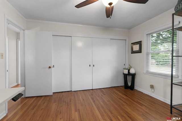 3920 Randolph St, Lincoln, NE 68510 - unfurnished bedroom featuring a closet, wood finished floors, crown molding, and a ceiling fan