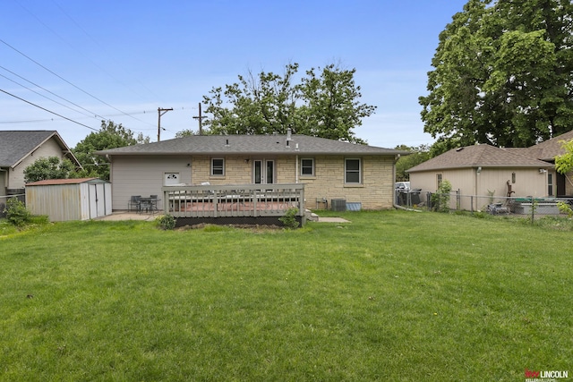 3920 Randolph St, Lincoln, NE 68510 - back of house featuring a deck, stone siding, and central AC unit