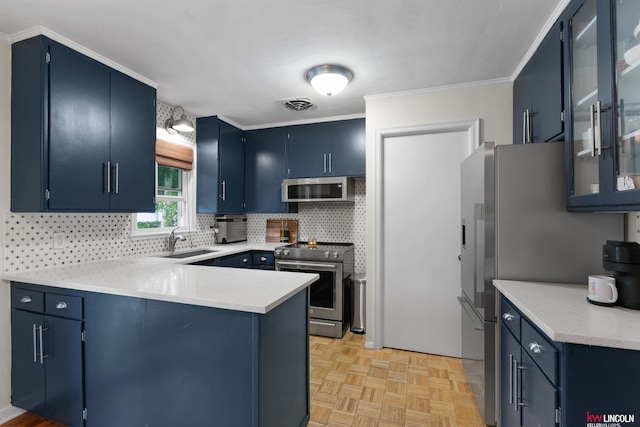 3920 Randolph St, Lincoln, NE 68510 - kitchen with appliances with stainless steel finishes, blue cabinets, a sink, a peninsula, and crown molding