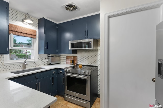 3920 Randolph St, Lincoln, NE 68510 - kitchen featuring stainless steel appliances, a sink, decorative backsplash, blue cabinetry, and crown molding