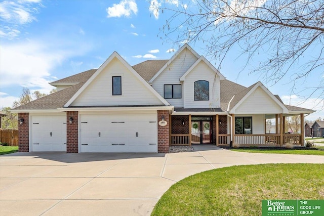 16831 Chandler St, Omaha, NE 68136 - view of front facade featuring a porch, brick siding, driveway, and a shingled roof