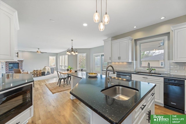 16831 Chandler St, Omaha, NE 68136 - kitchen featuring a sink, black microwave, a chandelier, backsplash, and recessed lighting