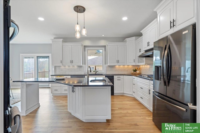 16831 Chandler St, Omaha, NE 68136 - kitchen with stainless steel appliances, a sink, dark countertops, white cabinetry, and recessed lighting