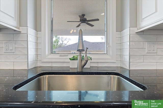 16831 Chandler St, Omaha, NE 68136 - kitchen view of a sink, a ceiling fan, dark stone counters, and backsplash