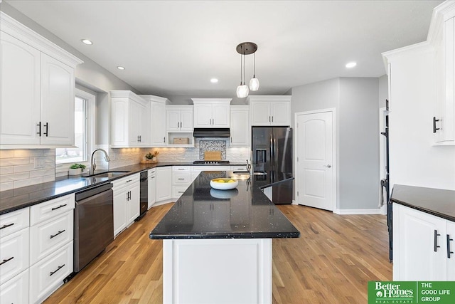 16831 Chandler St, Omaha, NE 68136 - kitchen featuring dishwasher, a sink, black fridge, under cabinet range hood, and an island with sink
