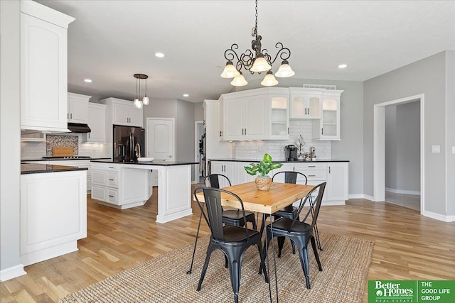 16831 Chandler St, Omaha, NE 68136 - dining area with light wood finished floors, baseboards, recessed lighting, and a chandelier