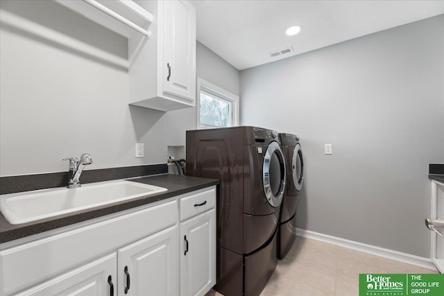 16831 Chandler St, Omaha, NE 68136 - washroom featuring washer and clothes dryer, cabinet space, light tile patterned flooring, and baseboards