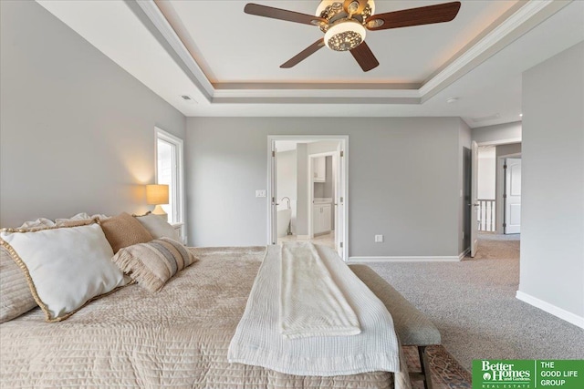 16831 Chandler St, Omaha, NE 68136 - bedroom featuring a tray ceiling, carpet floors, baseboards, connected bathroom, and ceiling fan