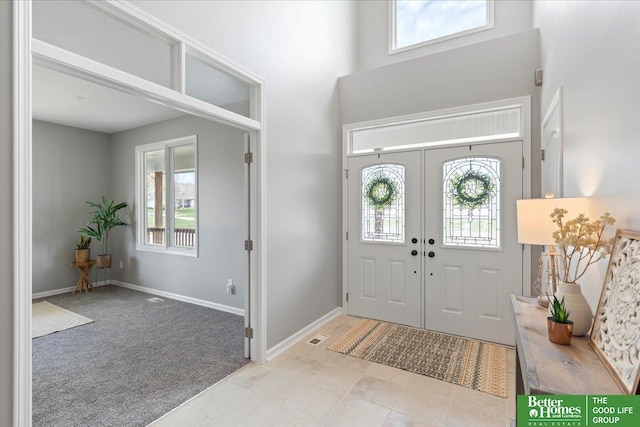 16831 Chandler St, Omaha, NE 68136 - foyer entrance with a towering ceiling, light carpet, baseboards, and french doors
