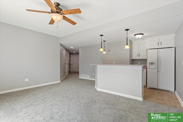 16831 Chandler St, Omaha, NE 68136 - kitchen featuring white fridge with ice dispenser, white cabinets, ceiling fan, decorative light fixtures, and light carpet