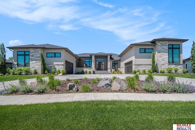 1520 S 218th St, Elkhorn, NE 68022 - prairie-style house featuring stone siding, an attached garage, and concrete driveway