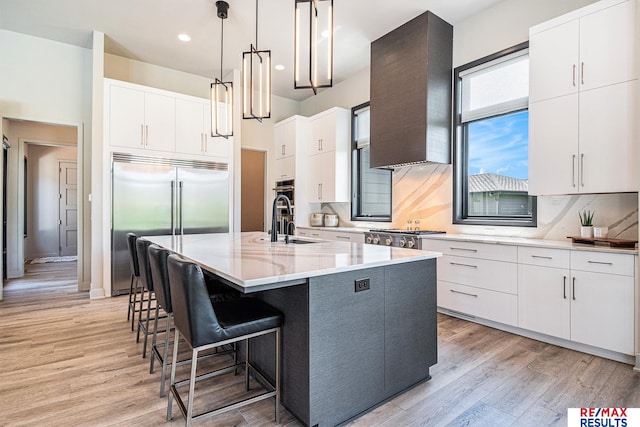 1520 S 218th St, Elkhorn, NE 68022 - kitchen with a sink, built in refrigerator, light wood-style floors, wall chimney range hood, and tasteful backsplash