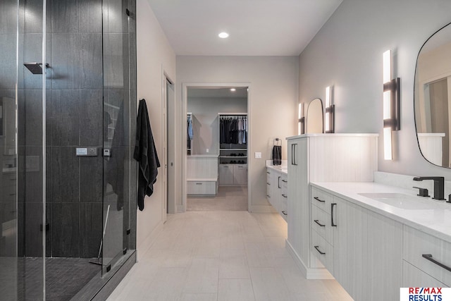 1520 S 218th St, Elkhorn, NE 68022 - bathroom featuring two vanities, a shower stall, a spacious closet, and recessed lighting
