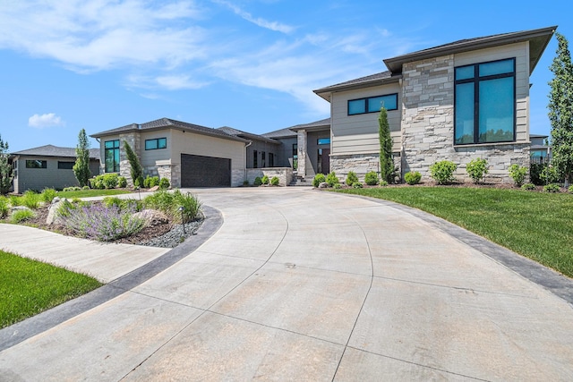 1520 S 218th St, Elkhorn, NE 68022 - view of front of house with stone siding, a garage, concrete driveway, and a front yard