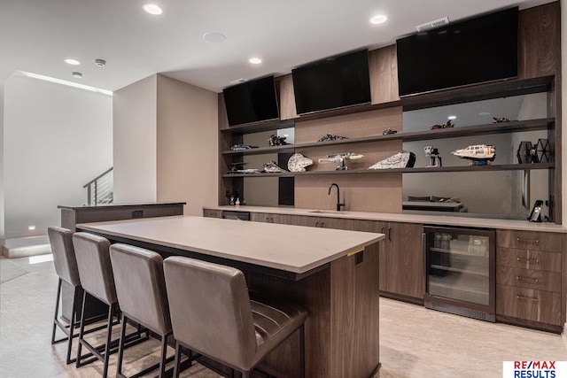 1520 S 218th St, Elkhorn, NE 68022 - kitchen featuring wine cooler, open shelves, a center island, a kitchen breakfast bar, and modern cabinets