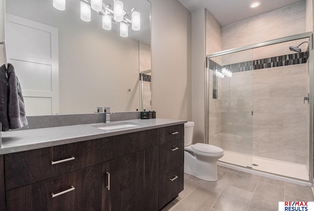 1520 S 218th St, Elkhorn, NE 68022 - full bath featuring toilet, vanity, a stall shower, tile patterned flooring, and recessed lighting