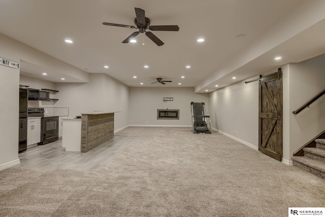 11051 Edgewater Dr, Papillion, NE 68046 - unfurnished living room featuring a barn door, light colored carpet, recessed lighting, stairs, and ceiling fan