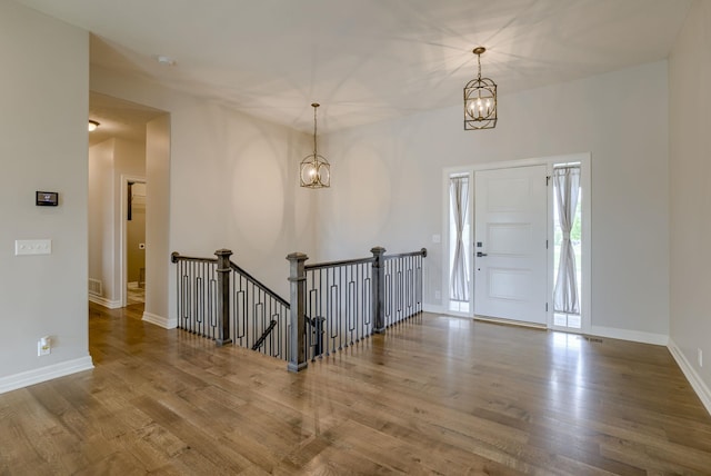 11051 Edgewater Dr, Papillion, NE 68046 - entryway with wood finished floors, a chandelier, and baseboards