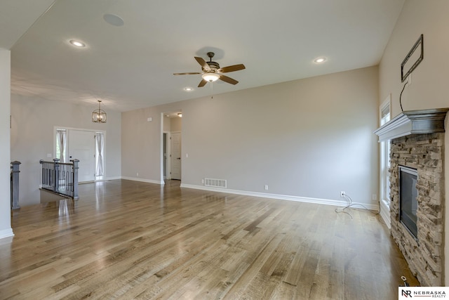 11051 Edgewater Dr, Papillion, NE 68046 - unfurnished living room featuring ceiling fan, light wood finished floors, a stone fireplace, recessed lighting, and baseboards