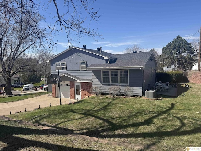 7624 Nebraska Ave, Omaha, NE 68134 - back of house with driveway, cooling unit, a garage, and a yard