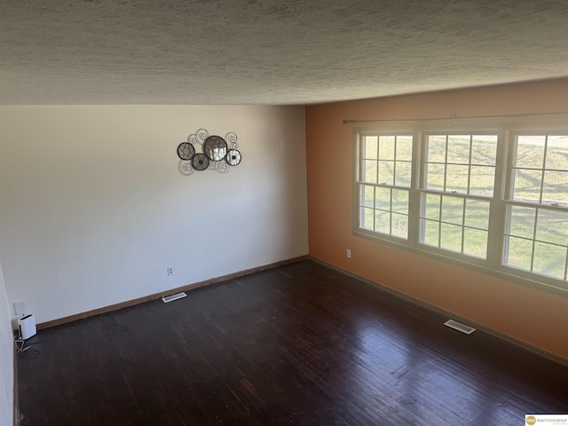 7624 Nebraska Ave, Omaha, NE 68134 - spare room featuring dark wood finished floors, baseboards, a textured ceiling, and a chandelier