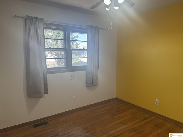 7624 Nebraska Ave, Omaha, NE 68134 - unfurnished room featuring ceiling fan, dark wood-style floors, and baseboards