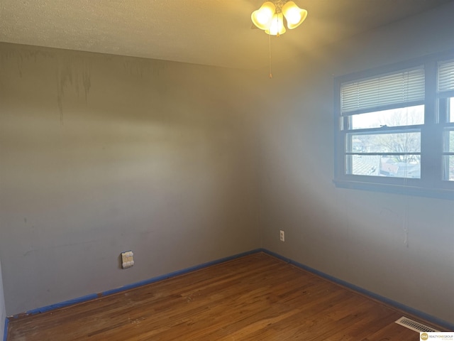 7624 Nebraska Ave, Omaha, NE 68134 - spare room featuring wood finished floors, a ceiling fan, and baseboards