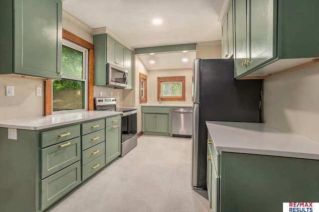 4709 Cuming St, Omaha, NE 68132 - kitchen featuring green cabinets, stainless steel appliances, light countertops, a sink, and recessed lighting