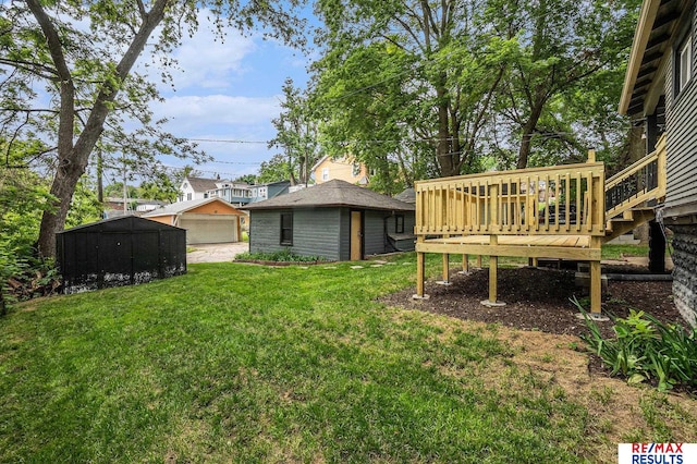 4709 Cuming St, Omaha, NE 68132 - view of grassy yard with a garage, a wooden deck, and an outdoor structure
