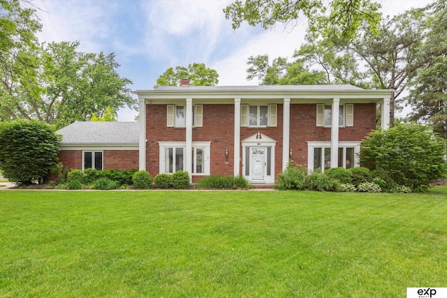 12212 Leavenworth Rd, Omaha, NE 68154 - neoclassical / greek revival house featuring a front lawn, brick siding, and a chimney