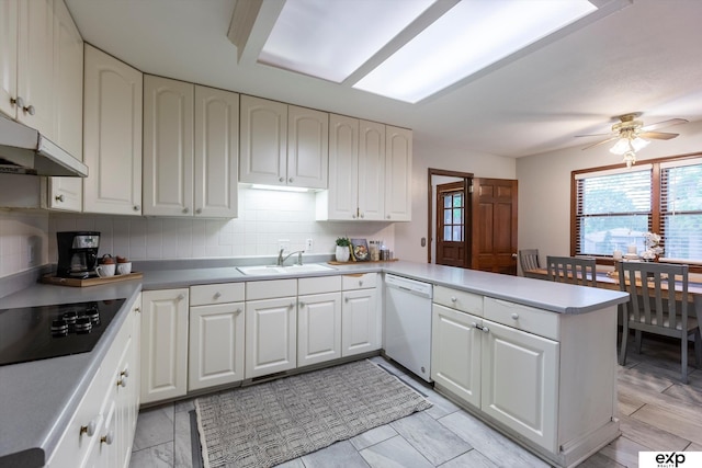 12212 Leavenworth Rd, Omaha, NE 68154 - kitchen with white dishwasher, black electric stovetop, a sink, under cabinet range hood, and a peninsula