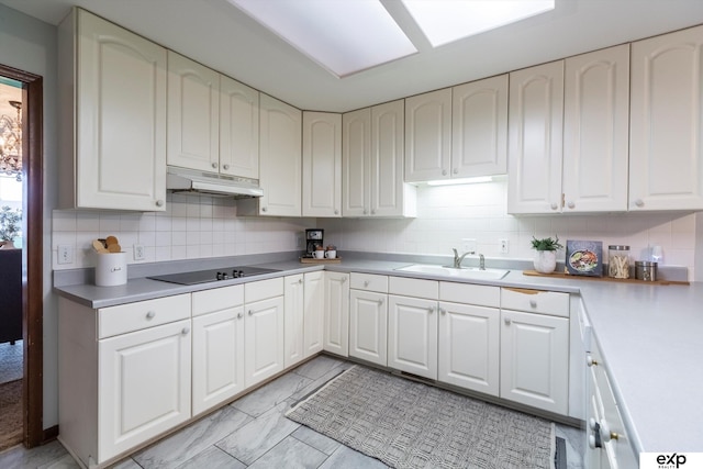 12212 Leavenworth Rd, Omaha, NE 68154 - kitchen featuring a sink, under cabinet range hood, decorative backsplash, black electric stovetop, and light countertops