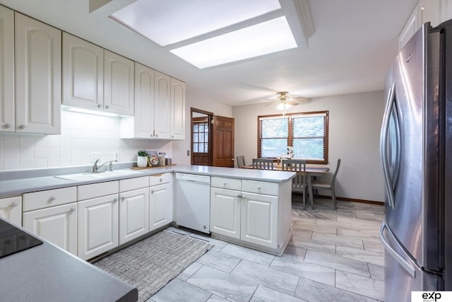 12212 Leavenworth Rd, Omaha, NE 68154 - kitchen featuring freestanding refrigerator, white dishwasher, a sink, a peninsula, and white cabinetry