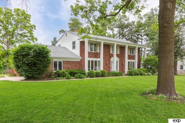 12212 Leavenworth Rd, Omaha, NE 68154 - neoclassical / greek revival house featuring brick siding, a chimney, a front yard, and roof with shingles
