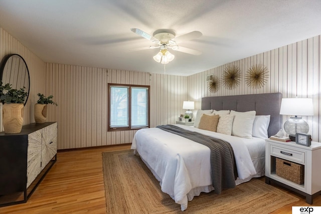 12212 Leavenworth Rd, Omaha, NE 68154 - bedroom featuring wallpapered walls, light wood-style floors, baseboards, and a ceiling fan