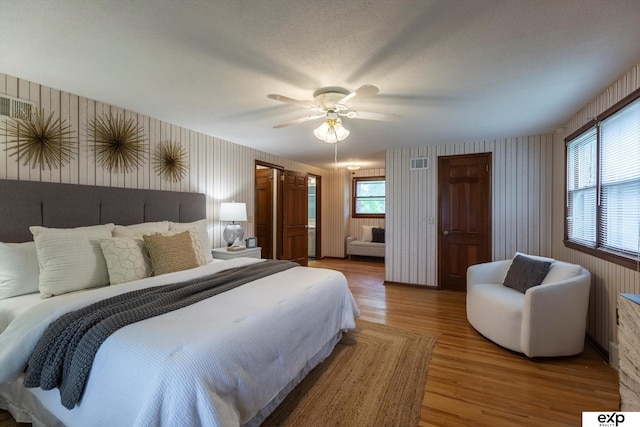 12212 Leavenworth Rd, Omaha, NE 68154 - bedroom with wallpapered walls, light wood finished floors, and a ceiling fan