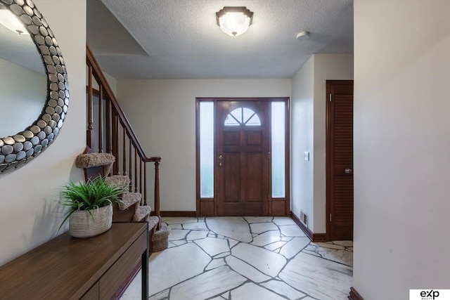 12212 Leavenworth Rd, Omaha, NE 68154 - entryway featuring a textured ceiling, stairway, and baseboards