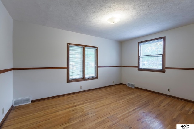 12212 Leavenworth Rd, Omaha, NE 68154 - unfurnished room featuring light wood finished floors, a textured ceiling, and baseboards