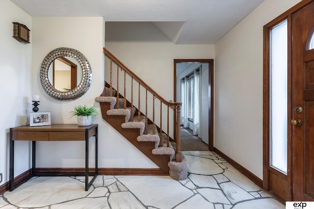 12212 Leavenworth Rd, Omaha, NE 68154 - foyer entrance with stairs and baseboards