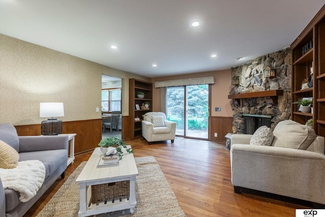 12212 Leavenworth Rd, Omaha, NE 68154 - living room with a wainscoted wall, light wood-style floors, healthy amount of natural light, recessed lighting, and a stone fireplace