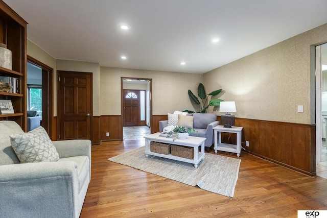 12212 Leavenworth Rd, Omaha, NE 68154 - living area with a wainscoted wall, light wood finished floors, wood walls, and recessed lighting