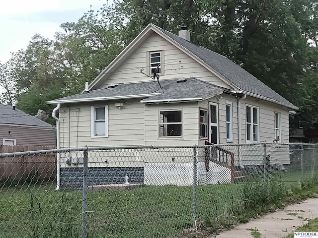 3359 N 41st St, Omaha, NE 68111 - view of property exterior featuring a shingled roof and a chimney