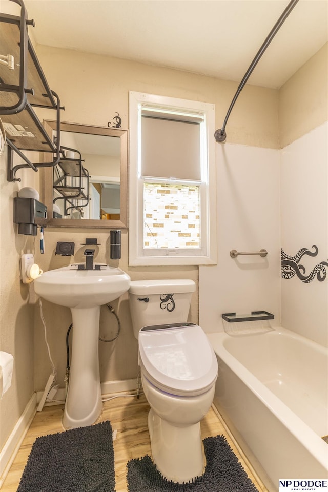 3359 N 41st St, Omaha, NE 68111 - bathroom featuring wood finished floors, toilet, shower / washtub combination, and baseboards