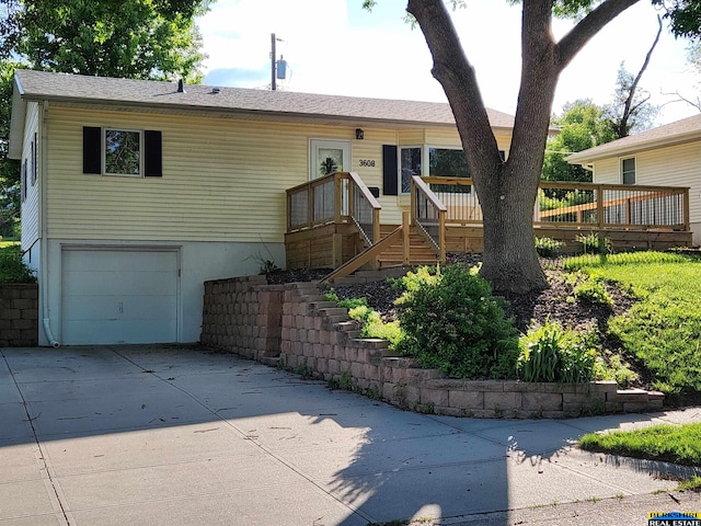 3608 S 87th Ave, Omaha, NE 68124 - view of front facade with a garage, a deck, and concrete driveway