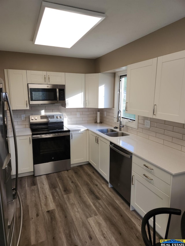 3608 S 87th Ave, Omaha, NE 68124 - kitchen featuring appliances with stainless steel finishes, a sink, and white cabinetry