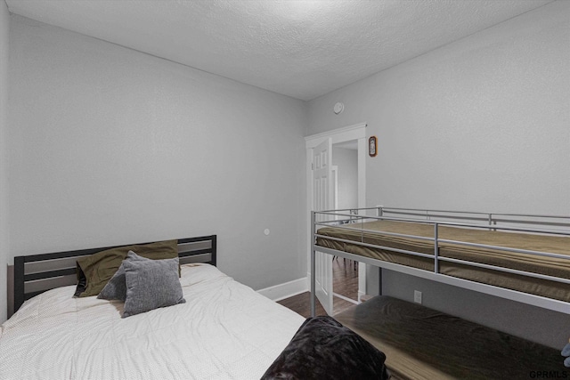 4411 Commercial Ave, Omaha, NE 68110 - bedroom featuring wood finished floors, baseboards, and a textured ceiling