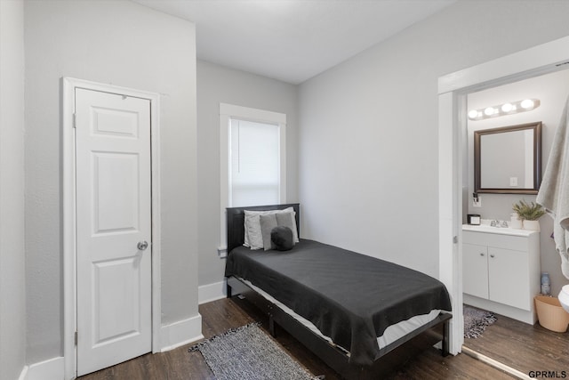 4411 Commercial Ave, Omaha, NE 68110 - bedroom with dark wood-style flooring, baseboards, and a sink