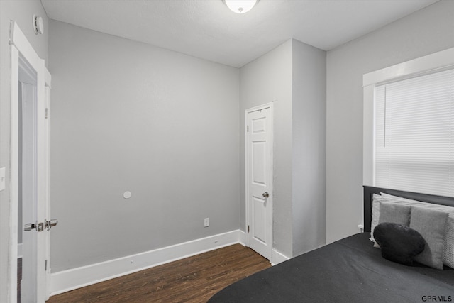 4411 Commercial Ave, Omaha, NE 68110 - unfurnished bedroom featuring dark wood-type flooring and baseboards